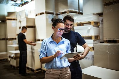 person listening to manager talk about what to do next in warehouse