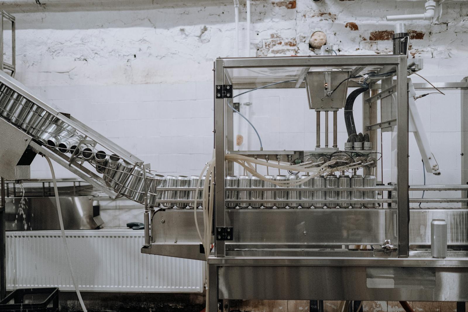 Automated beverage can packaging in a modern factory setting.